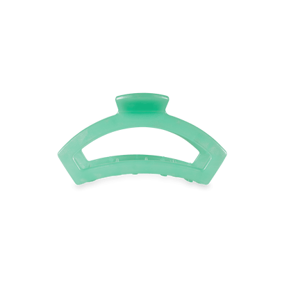 A mint green translucent hair claw clip on a solid white background.