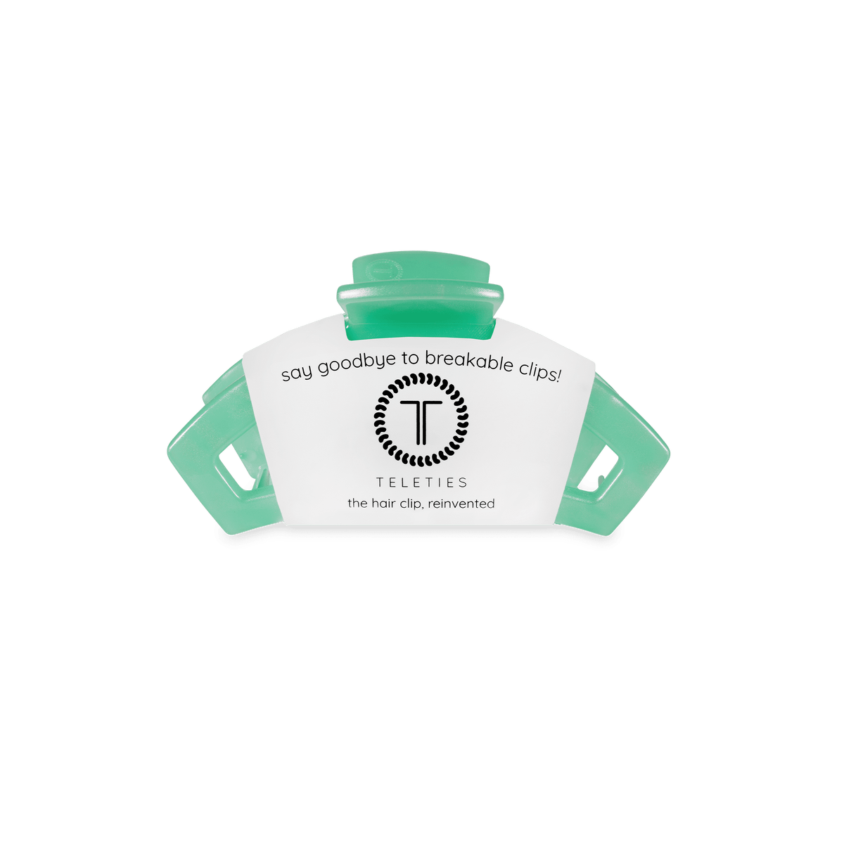 Teal hair clip with a white label on a green background