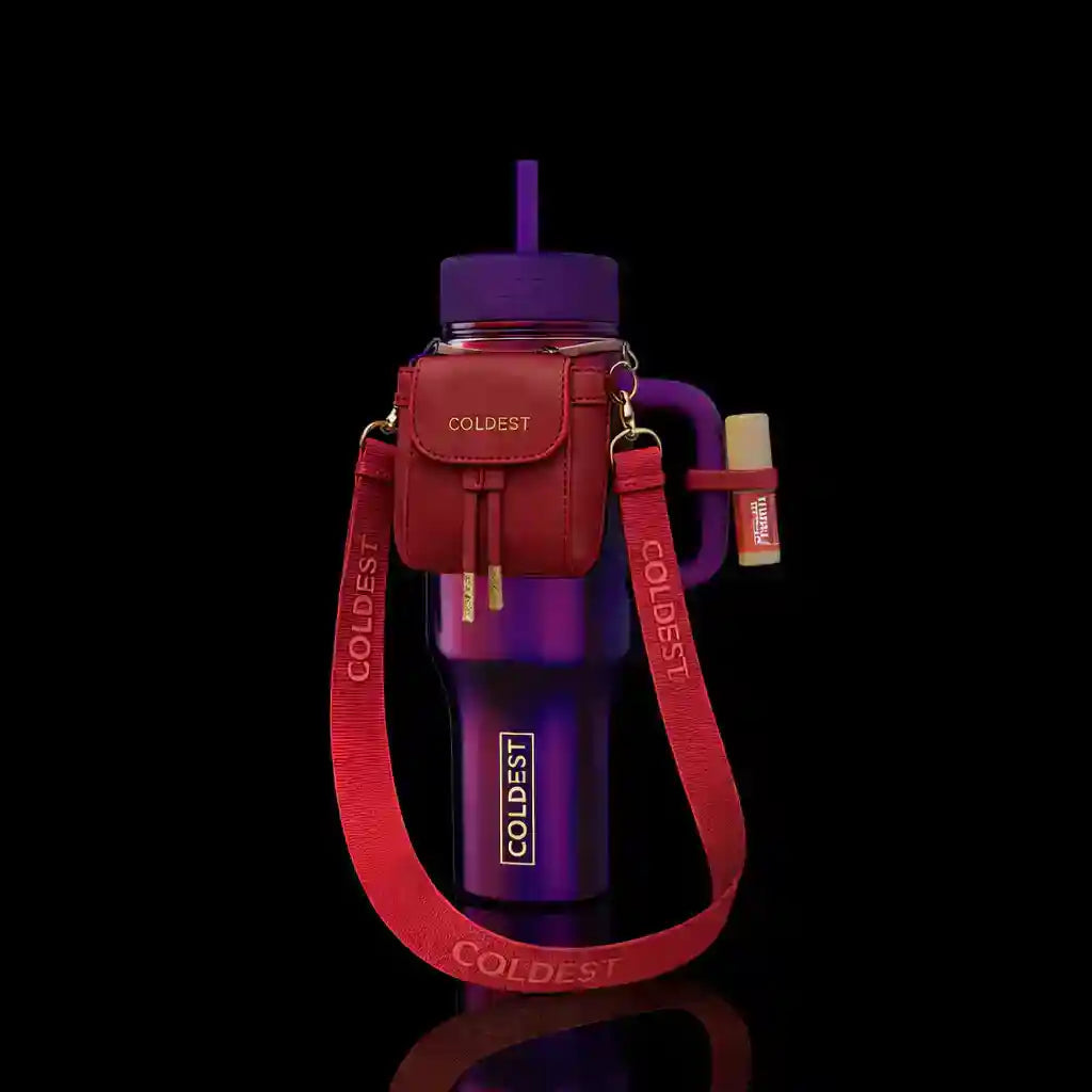 Purple water bottle with red carrying strap and case on a black background
