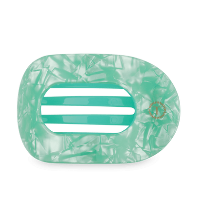 A mint green translucent hair claw clip with a marbled pattern and three horizontal slits, shown on a white background.