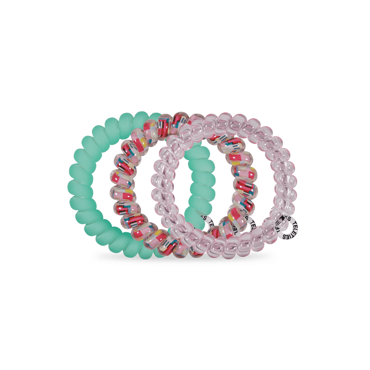 TELETIES Spring Splash large coil hair ties in pink, speckled clear and mint green, on a green background