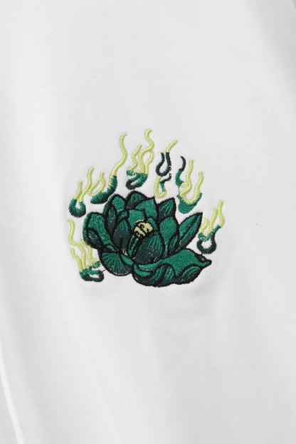 Embroidered green and yellow design on a white background