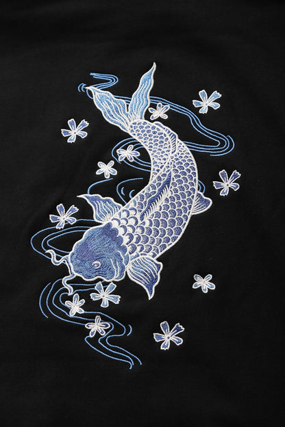Embroidered design of two koi fish and flowers on a black background